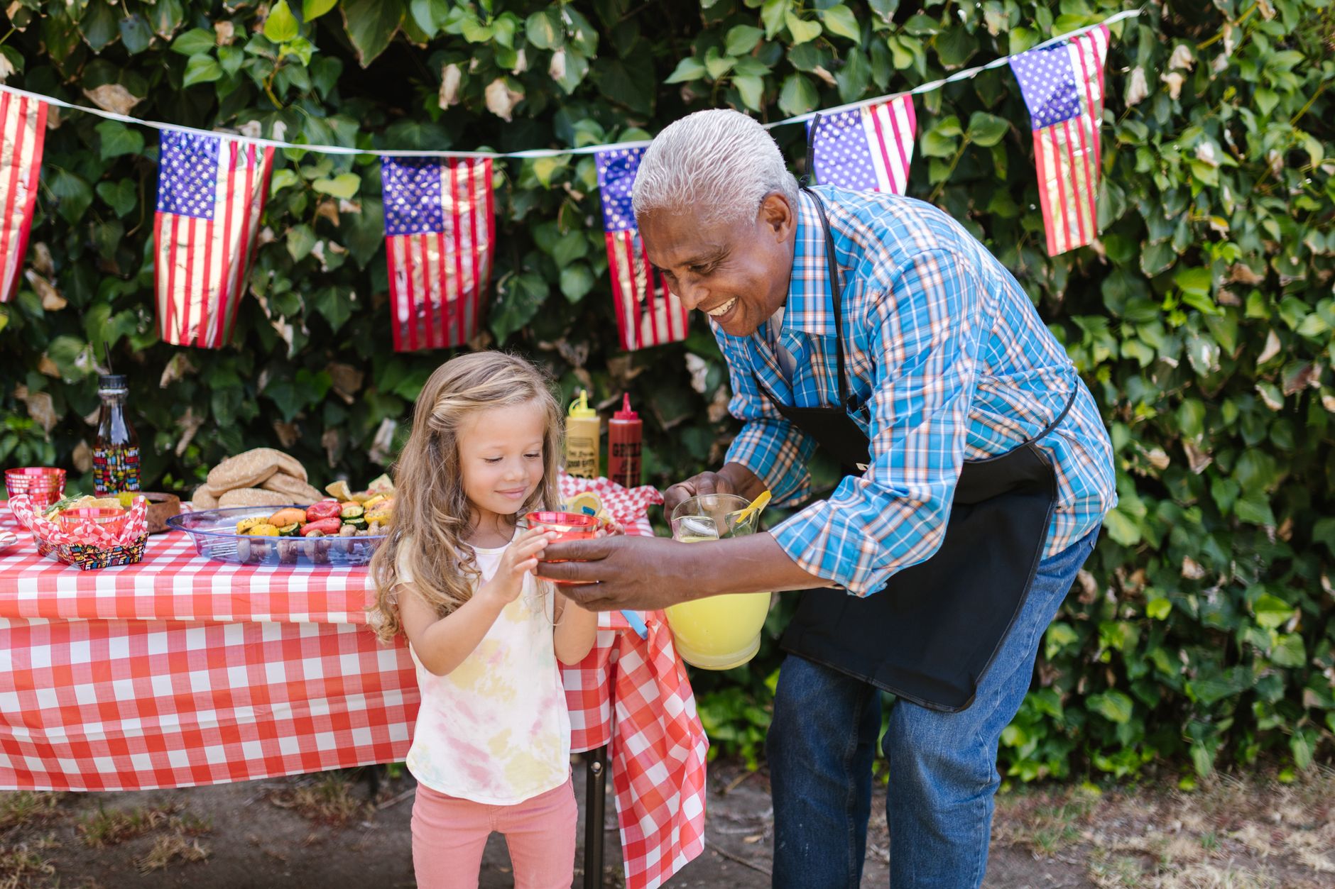 Colourful bunting at a street party community gathering symbolising neighbourhood happiness