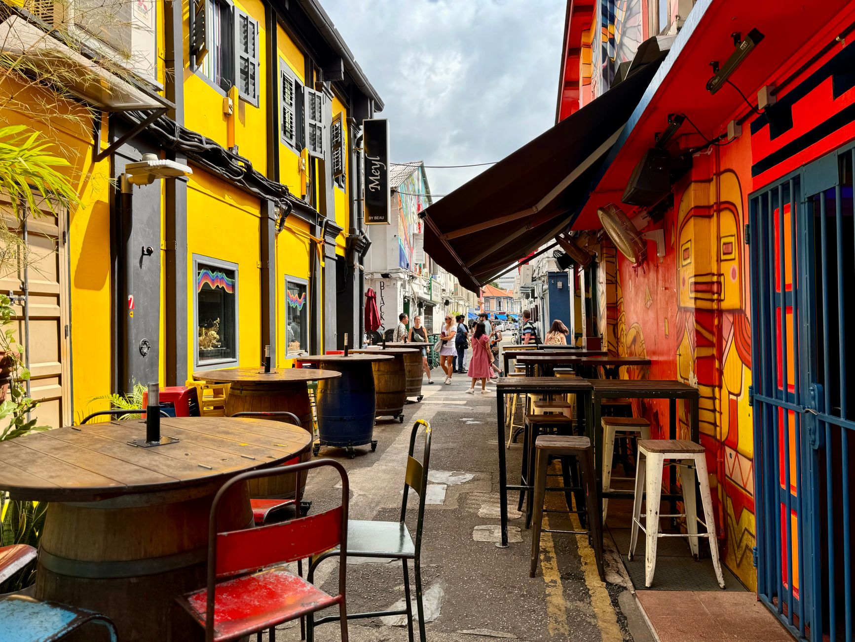 Neighbours gathered at street party tables celebrating community happiness on a British residential road
