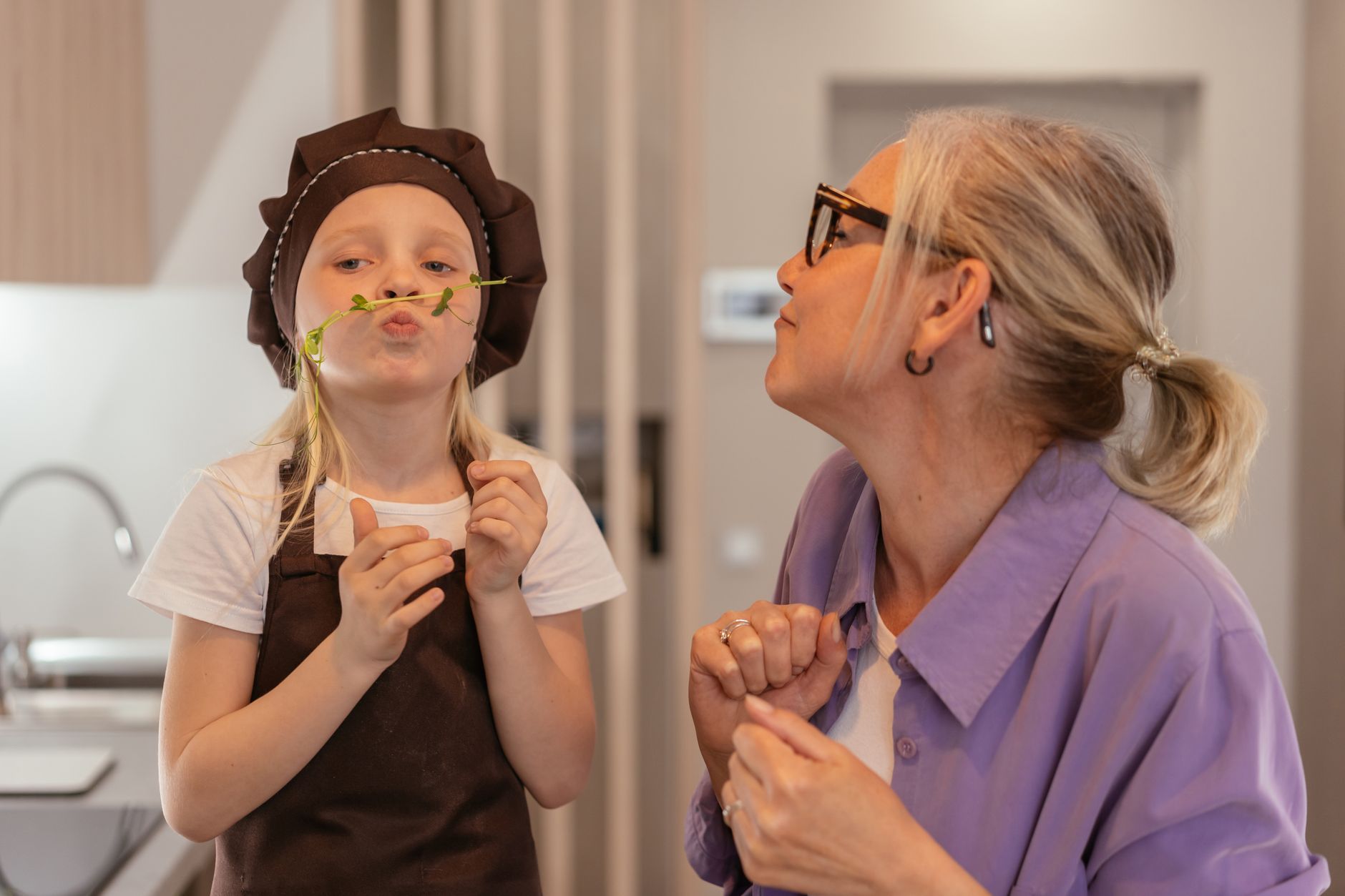 Grandmother and grandchild cooking together, a daily moment of multigenerational living UK wellbeing